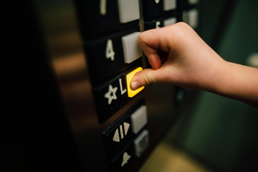 pexels photo 3861787 3861787 A close-up shot of a hand pushing the 'L' button in an elevator, indoors.